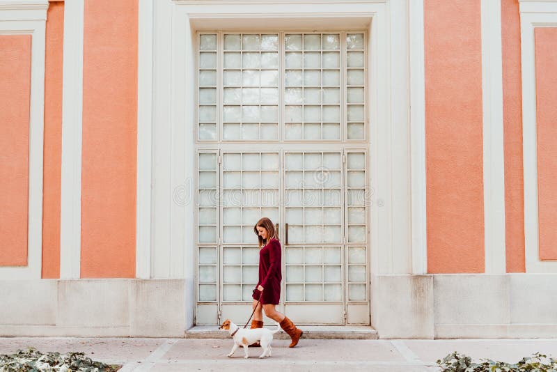 young woman and her cute jack russell dog walking by the city. Love for animals concept royalty free stock photography young woman and her cute jack russell dog walking by the city. Love for animals concept royalty free stock photography