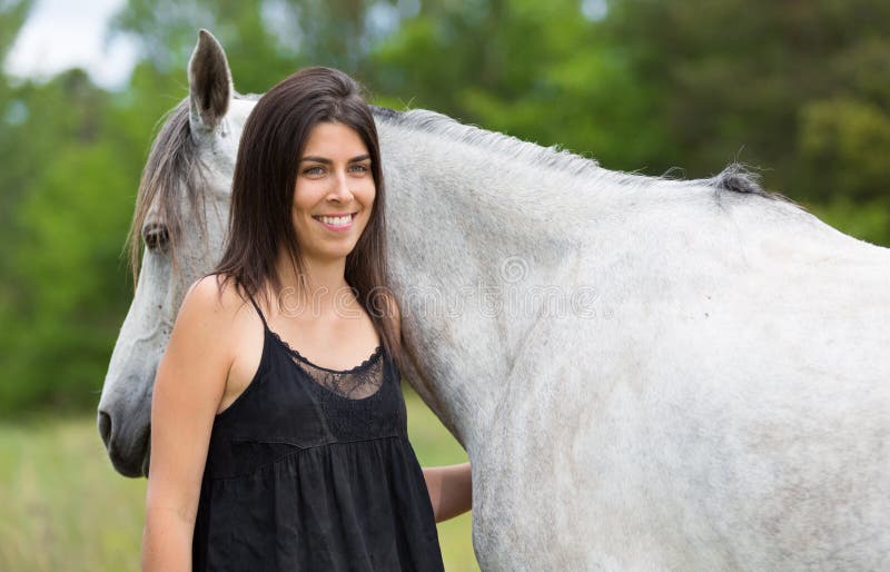 Young woman with her horse