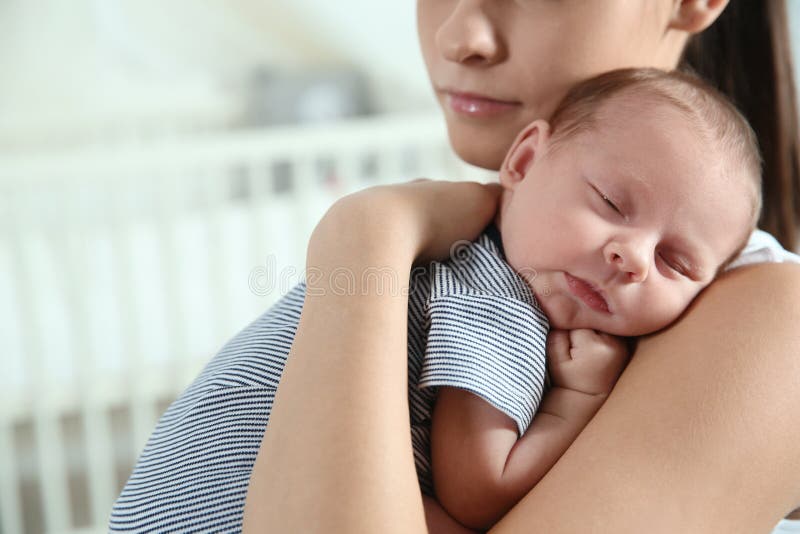 Young woman with her newborn baby at home stock photography Young woman with her newborn baby at home stock photography