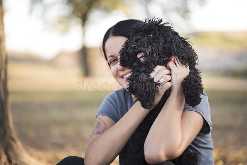 Young woman and her poodle puppy stock image Young woman and her poodle puppy stock image