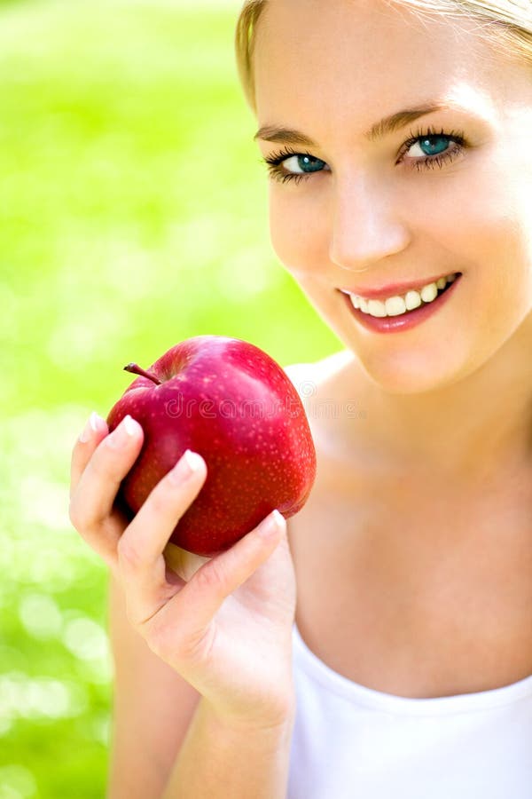 Young woman holding apple stock photo