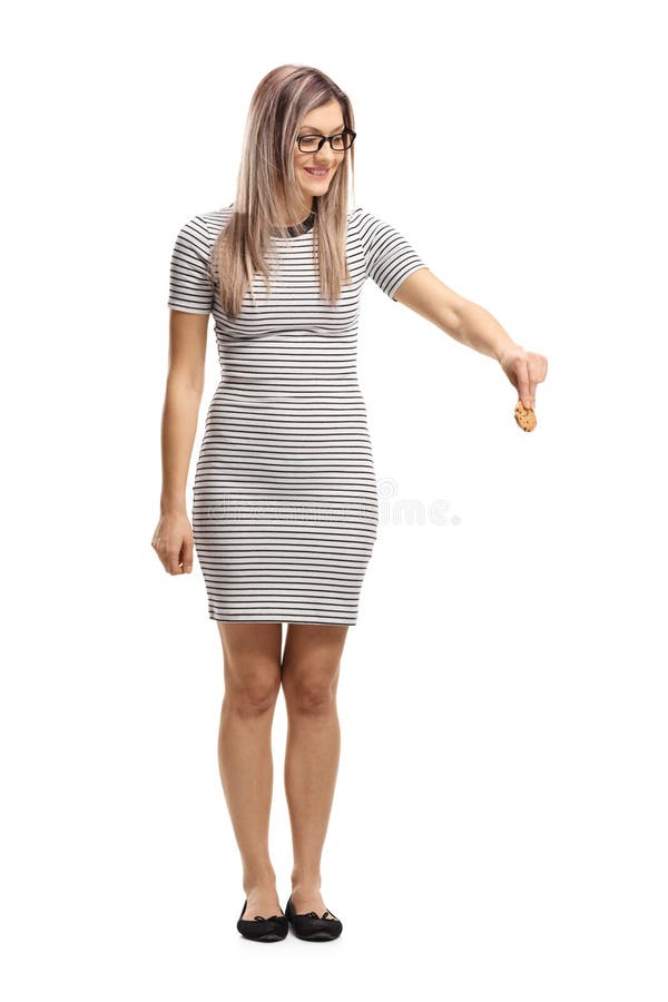 Young woman holding a biscuit and looking downwards royalty free stock photos Young woman holding a biscuit and looking downwards royalty free stock photos
