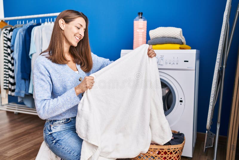 Young Woman Holding Clean Towel Washing Clothes at Laundry Room Stock ...
