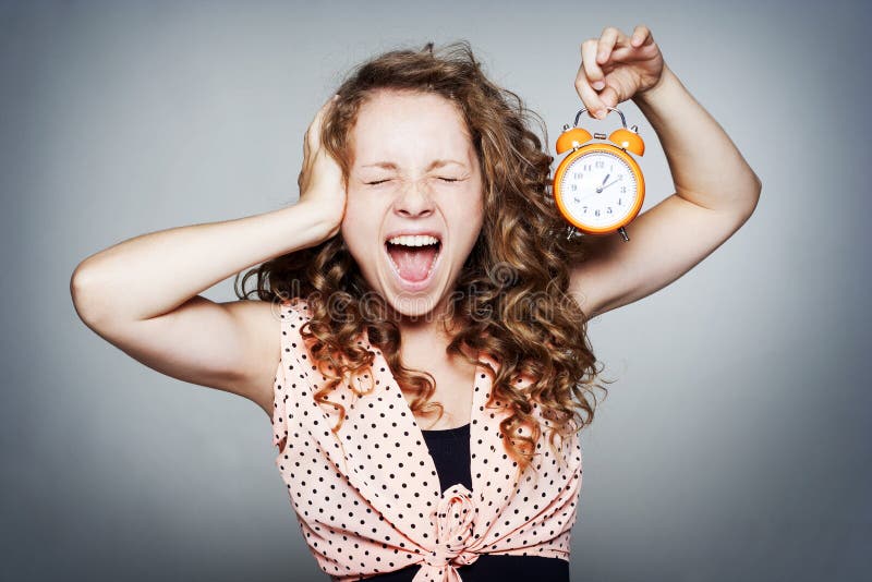 Young woman holding a clock