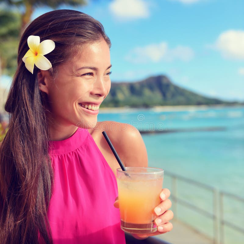 Young Woman Holding Cocktail Glass At Beach Bar