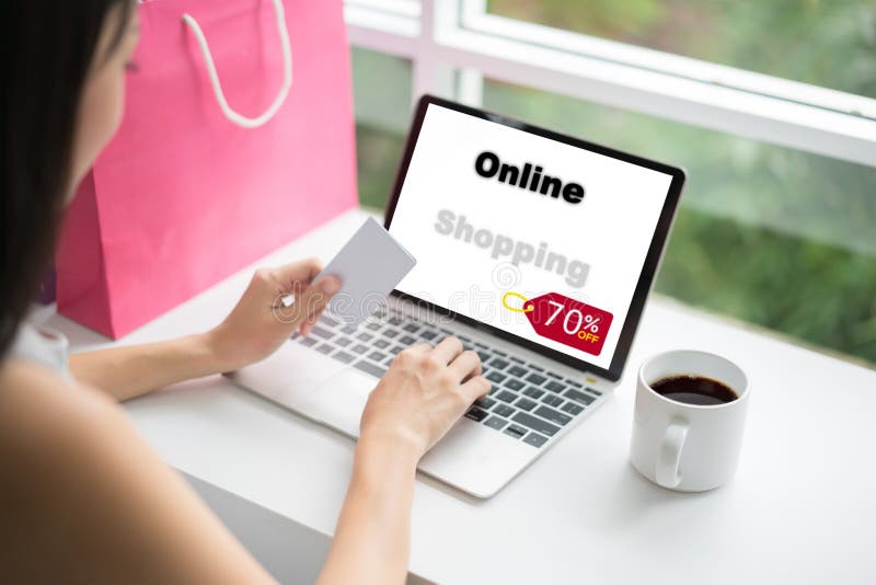 Young woman holding credit card and using laptop computer in cafe. Online shopping concept stock images Young woman holding credit card and using laptop computer in cafe. Online shopping concept stock images
