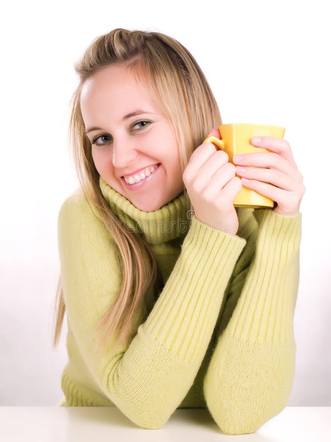 young woman holding a cup of hot drink
