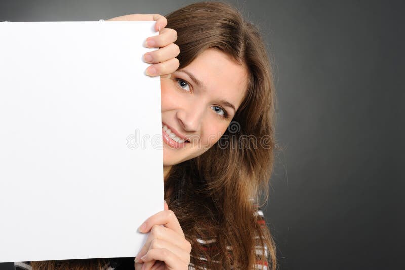 Young woman holding empty white board
