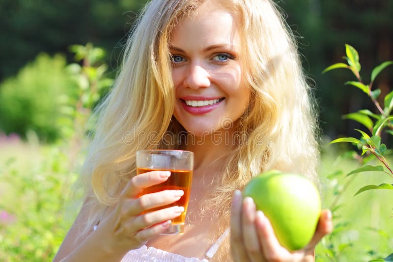 Young woman holding green apple