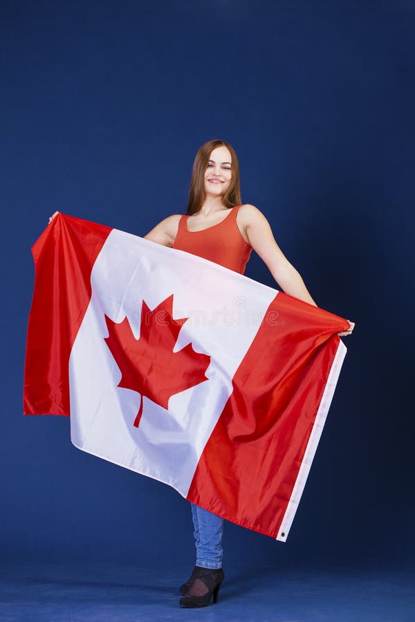 Young Woman Holding a Large Canadian Flag Stock Photo - Image of adult ...