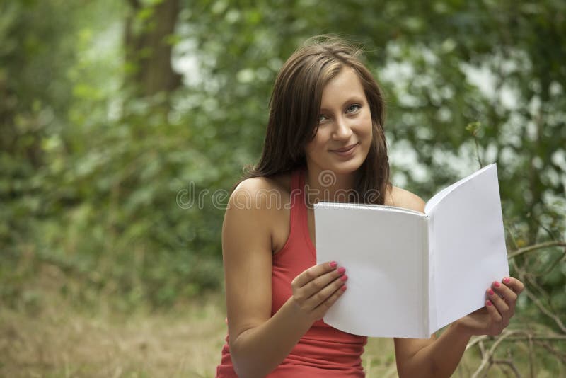 Young woman holding magazine