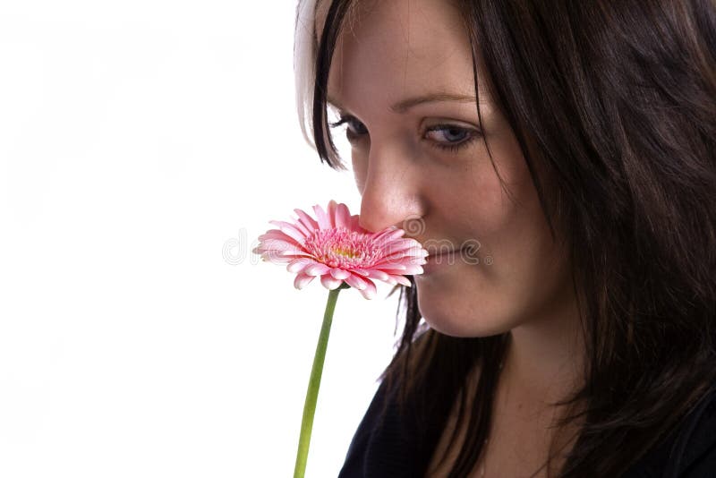 Young woman holding a pink flower stock photography