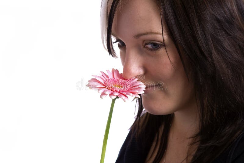 Young woman holding a pink flower