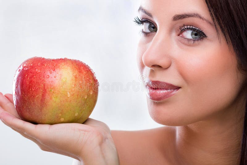 Young woman holding red apple