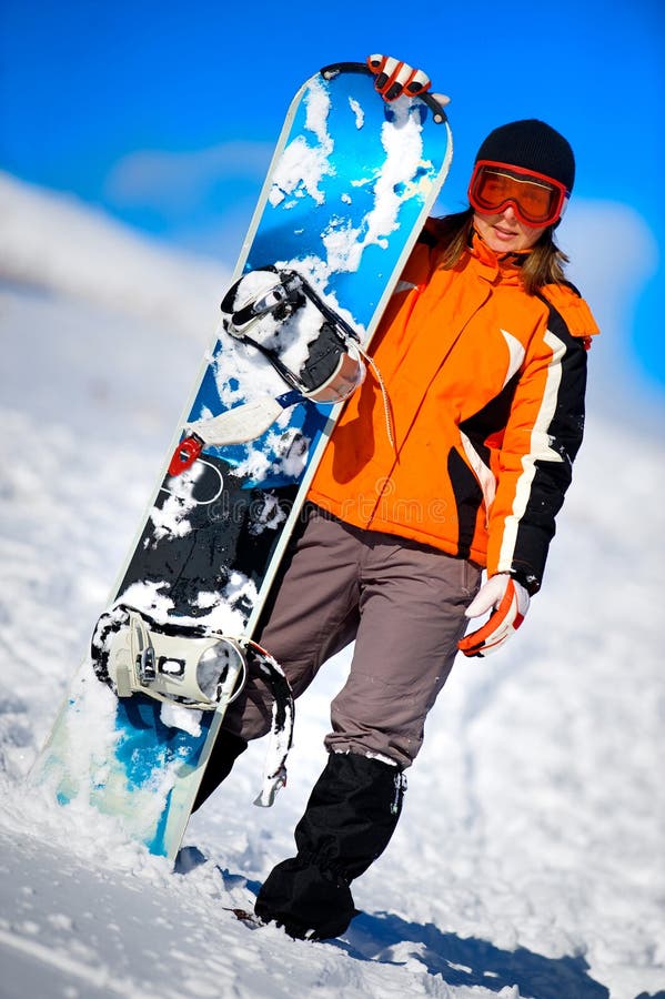 Young woman holding a snowboard