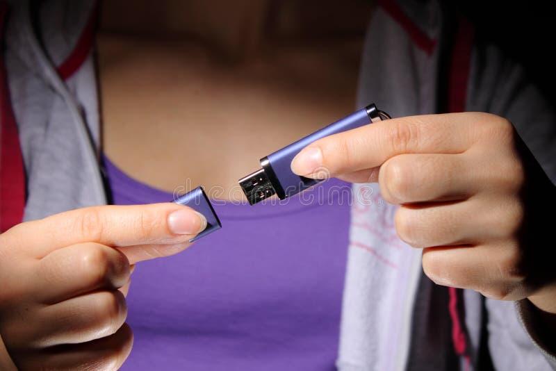 A young woman holding a USB flash memory stick