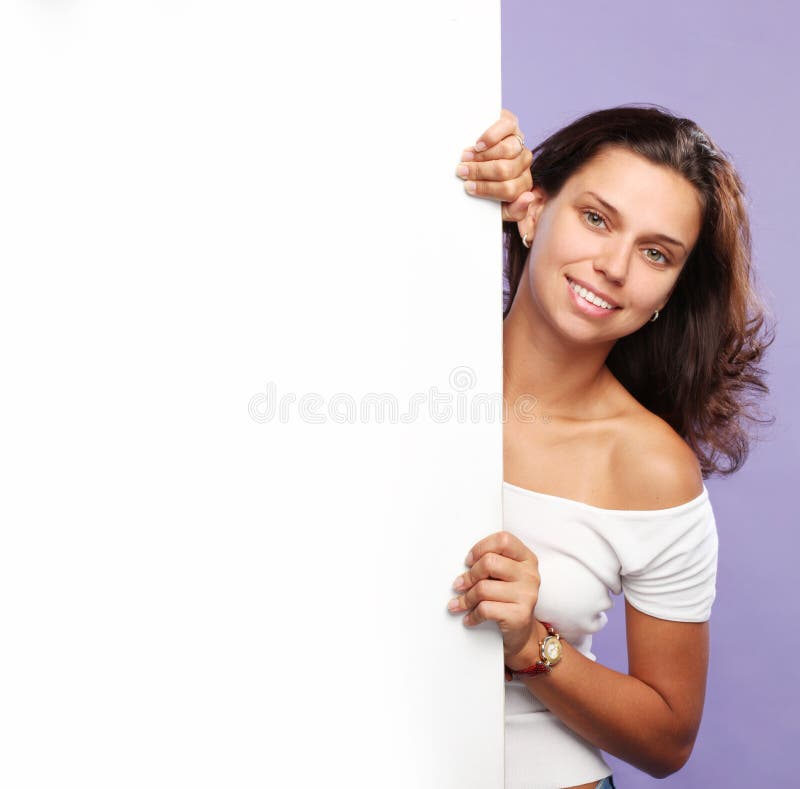 Young woman holds white board.