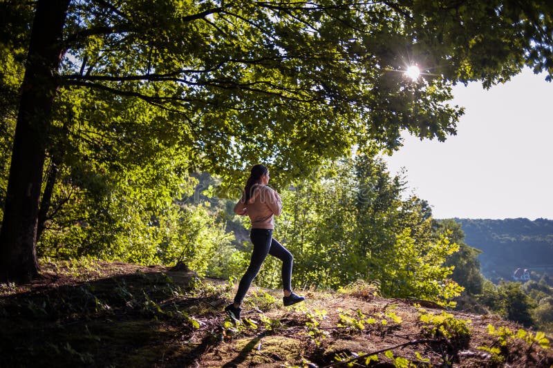 Young Girl Jogging in the Woods on a Sunny Morning. Stock Image - Image ...