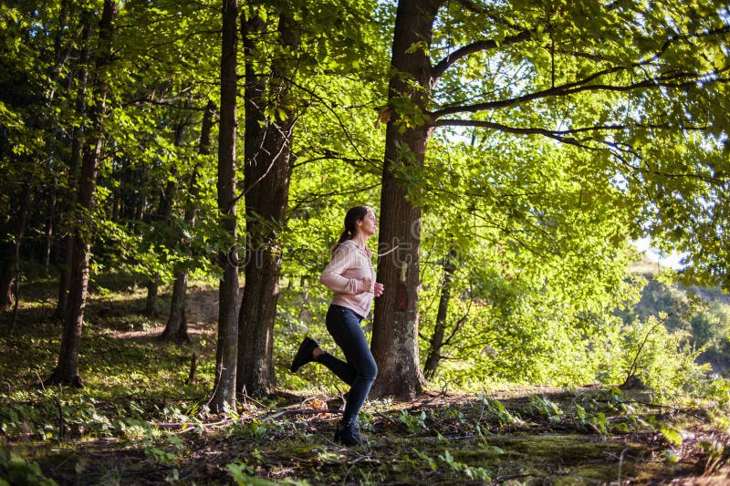 Young Girl Jogging in the Woods on a Sunny Morning. Stock Photo - Image ...