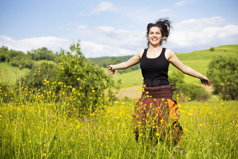 Young woman jumping in a field of flowers