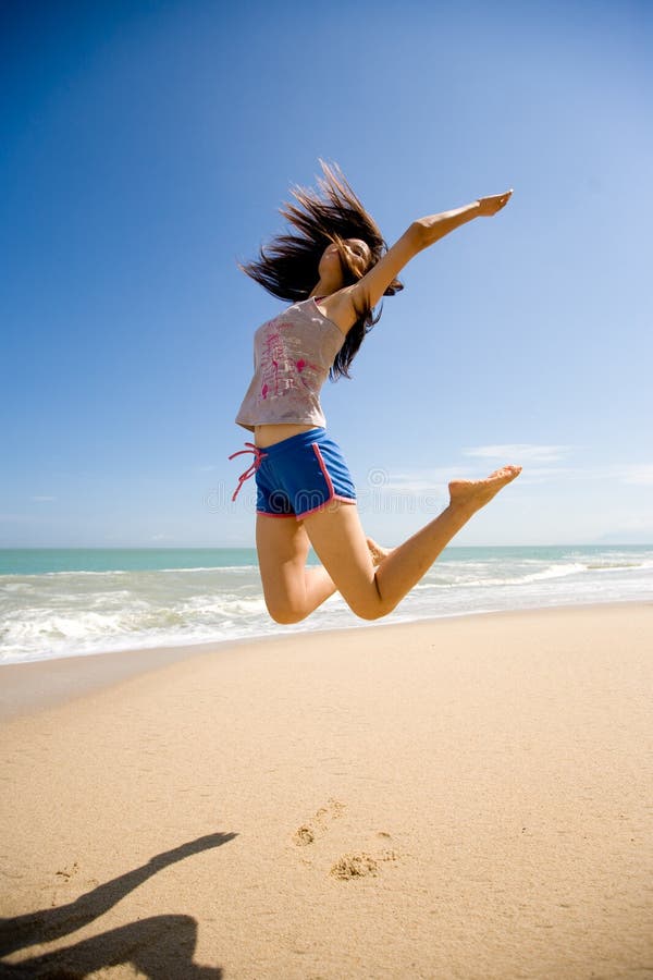 Young woman jumping happily