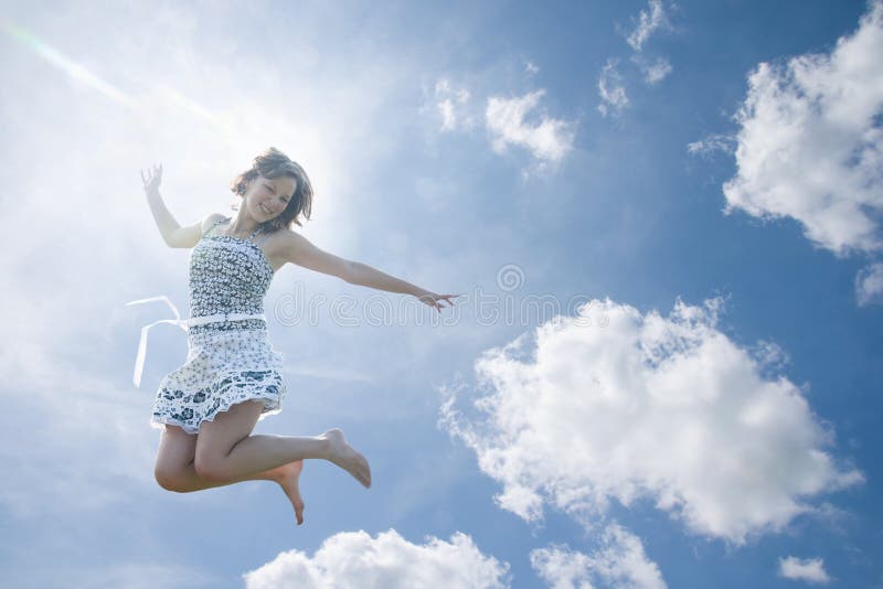 Young woman jumping in sky royalty free stock photography Young woman jumping in sky royalty free stock photography