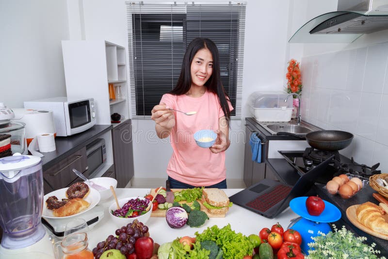 Woman in kitchen preparing salad dressing in bowl royalty free stock image Woman in kitchen preparing salad dressing in bowl royalty free stock image