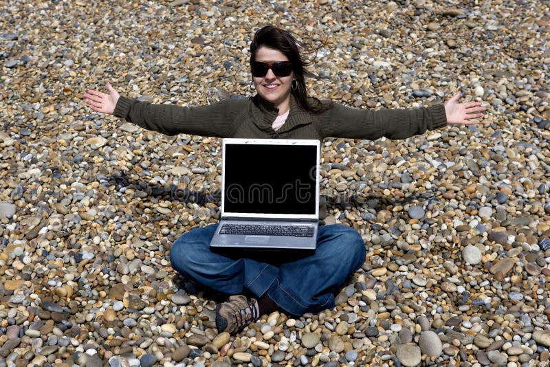Young woman with laptop computer in beach