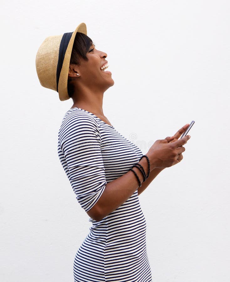 Young woman laughing and holding mobile phone