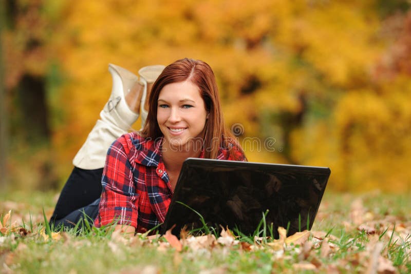 Young Woman laying down with a laptop computer