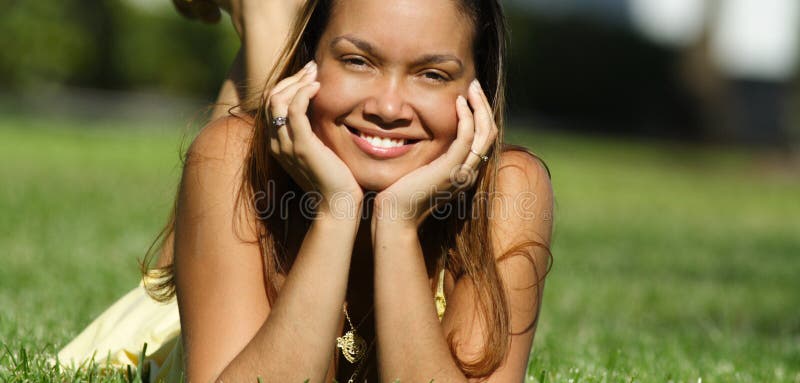 Young woman laying on grass