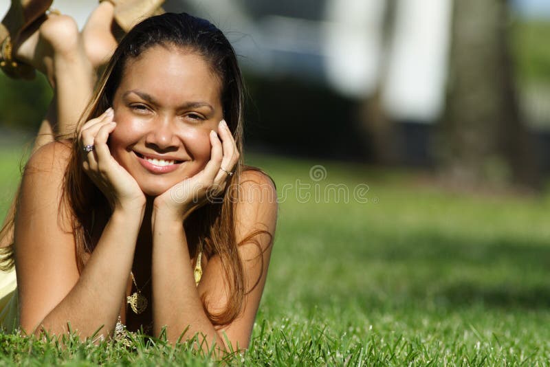 Young woman laying on grass