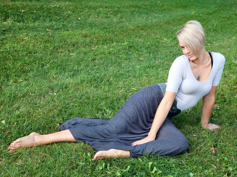 Young Woman Laying on the Green Grass Stock Image - Image of people