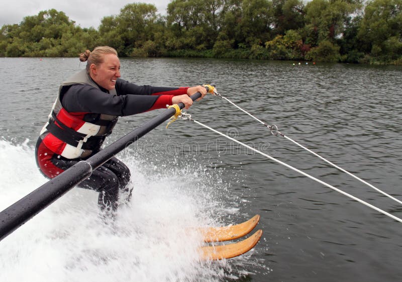 Young woman learning to water ski