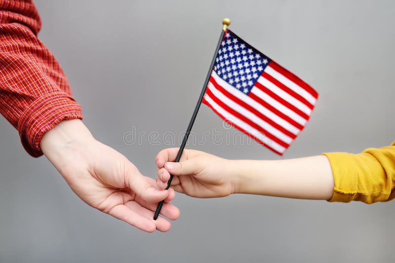 Young woman and little child holding american flag. Independence Day concept royalty free stock image Young woman and little child holding american flag. Independence Day concept royalty free stock image