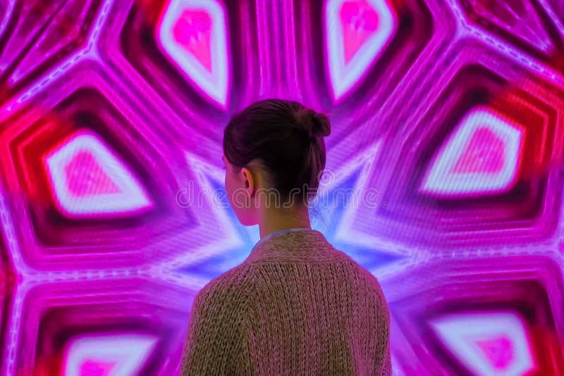 Young woman looking around at modern immersive exhibition royalty free stock photography