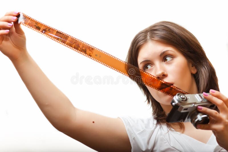 Young woman looking at photo film tape