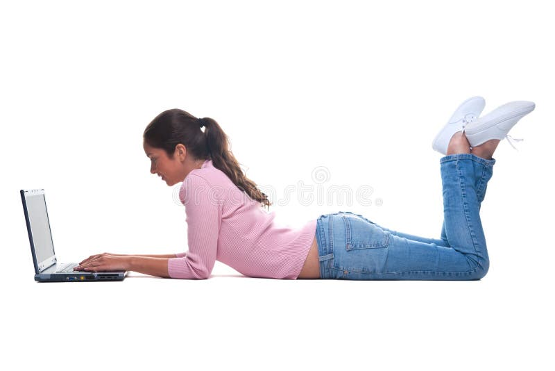 Young woman lying on floor using a laptop royalty free stock photos