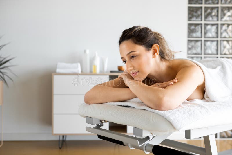 Young Woman Lying On The Massage Table In The Spa Salon Stock Image