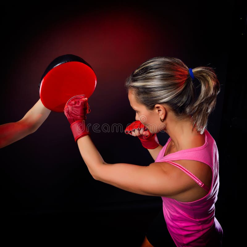 Young woman making a hard punch during training royalty free stock photo Young woman making a hard punch during training royalty free stock photo