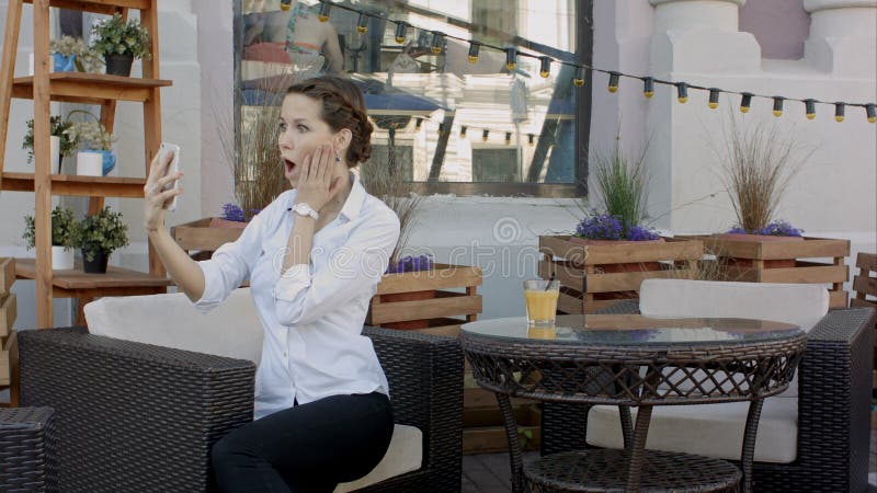 Young woman making self portrait using smartphone. girl making selfie. woman in cafe. woman alone. self portrait in cafe royalty free stock photos Young woman making self portrait using smartphone. girl making selfie. woman in cafe. woman alone. self portrait in cafe royalty free stock photos