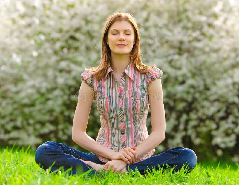 Young woman meditating outdoors