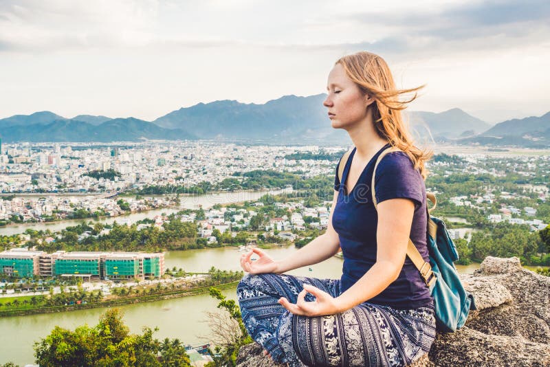 Young woman meditating over ancient city landscape on sunrise Copy space stock images Young woman meditating over ancient city landscape on sunrise Copy space stock images