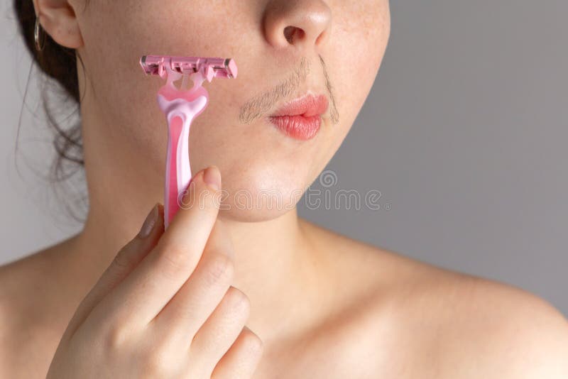 A Young Woman with a Mustache Holds a Razor To Her Cheek. the Concept of Getting Rid of Unwanted Facial Hair Stock Photo - Image of concept, lifestyle: 152532830 A Young Woman with a Mustache Holds a Razor To Her Cheek. the Concept of Getting Rid of Unwanted Facial Hair Stock Photo - Image of concept, lifestyle: 152532830