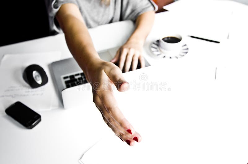 Young woman in office holding hand, small dof