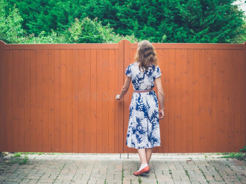 Young woman opening orange gate royalty free stock photos Young woman opening orange gate royalty free stock photos