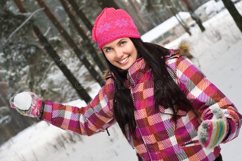 Young woman outdoor in winter plaing snawballs stock photography Young woman outdoor in winter plaing snawballs stock photography