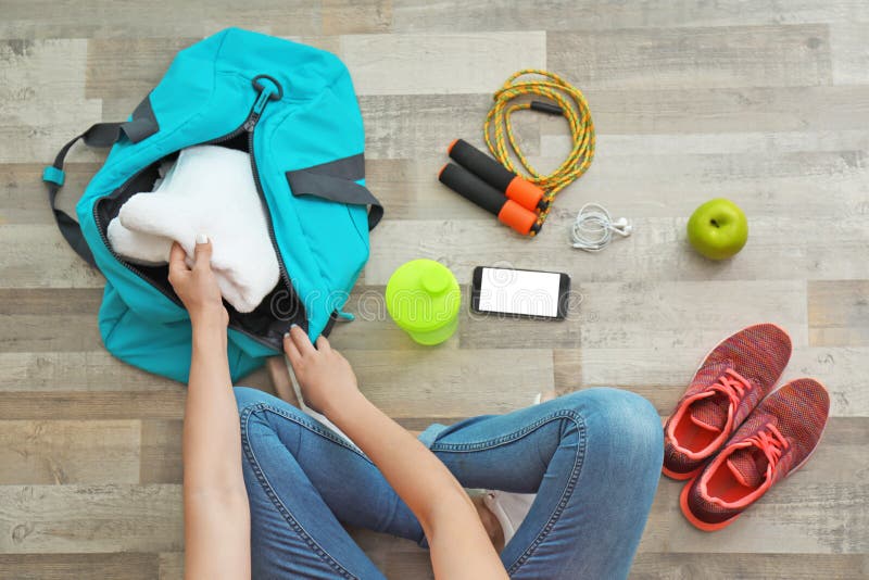 Young Woman Packing Sports Bag on Floor Stock Photo - Image of handle ...