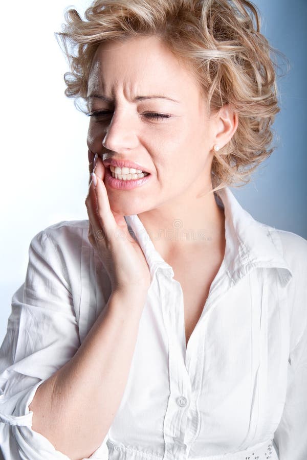 Young woman in pain is having toothache