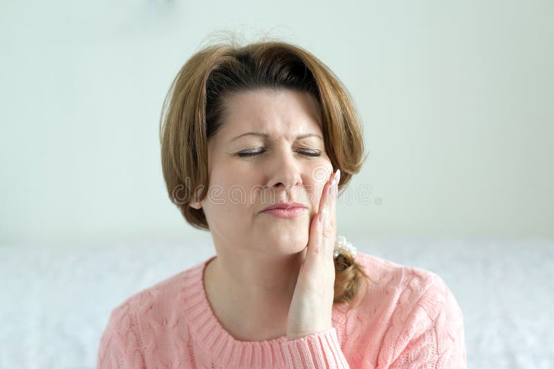 Young woman in pain is having toothache